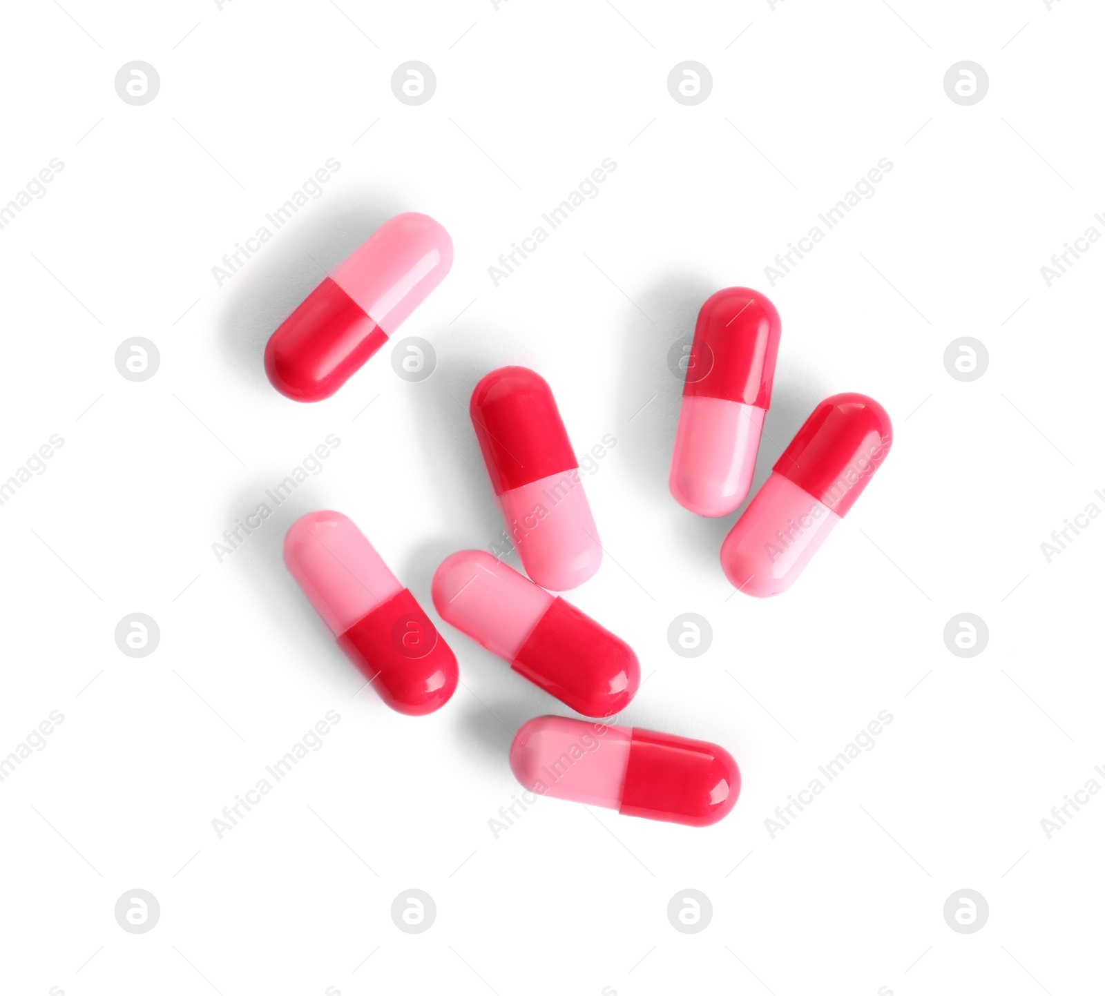 Photo of Many pink pills isolated on white, top view