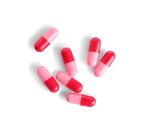 Many pink pills isolated on white, top view