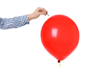 Photo of Woman piercing red balloon on white background, closeup