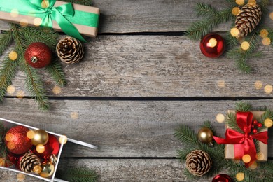 Christmas greeting card with space for text. Flat lay composition of fir tree branches and festive decor on wooden background