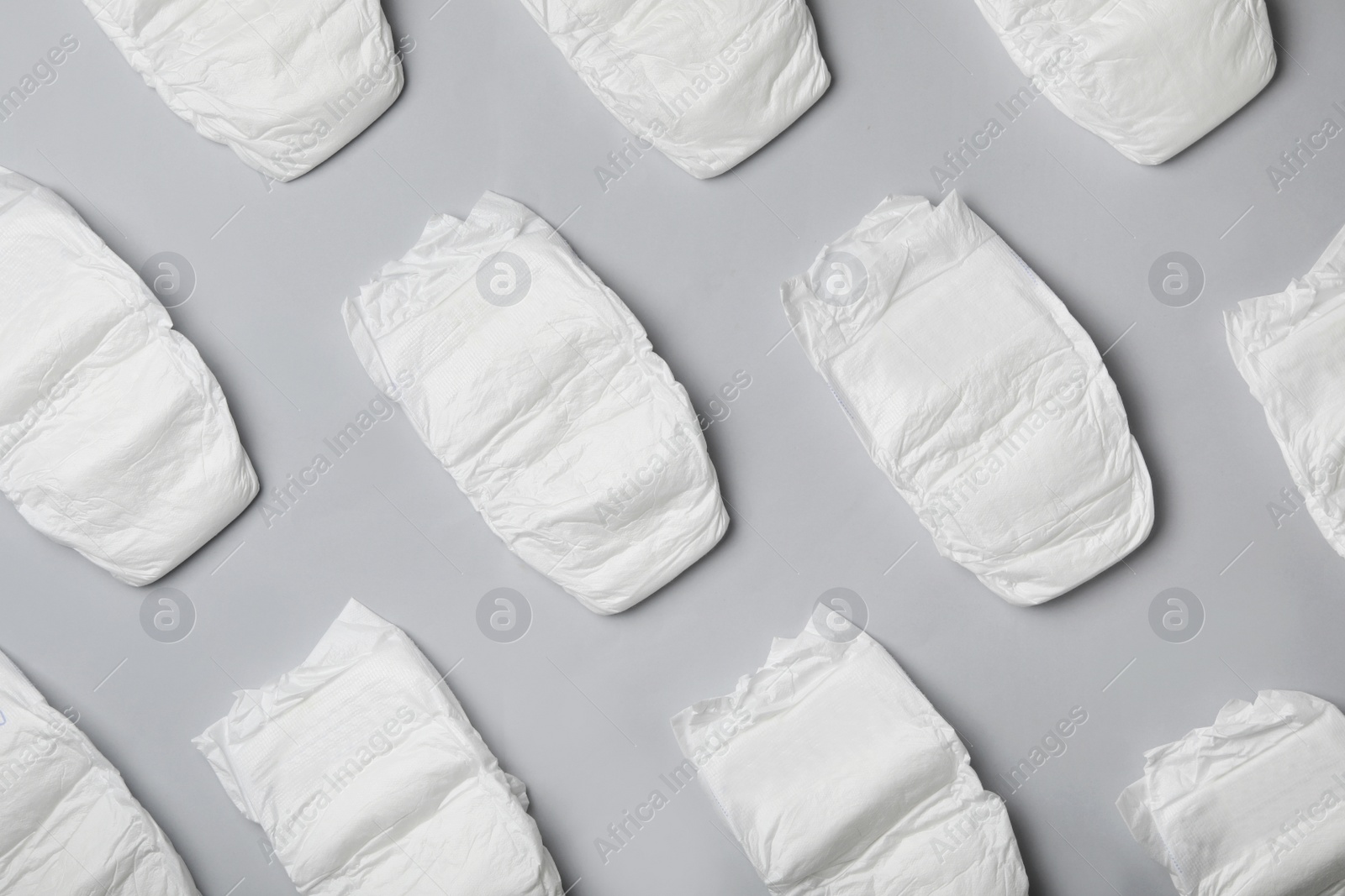 Photo of Flat lay composition with diapers on light grey background