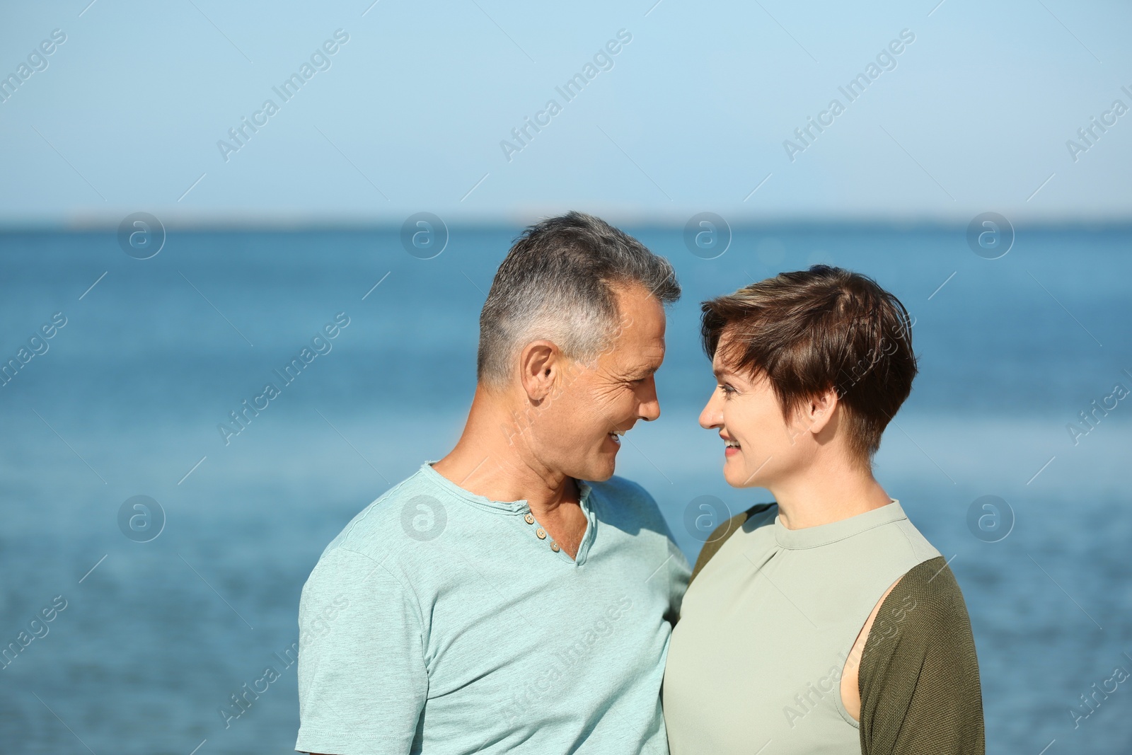 Photo of Happy mature couple at beach on sunny day