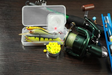 Photo of Fishing tackle on dark wooden background, closeup