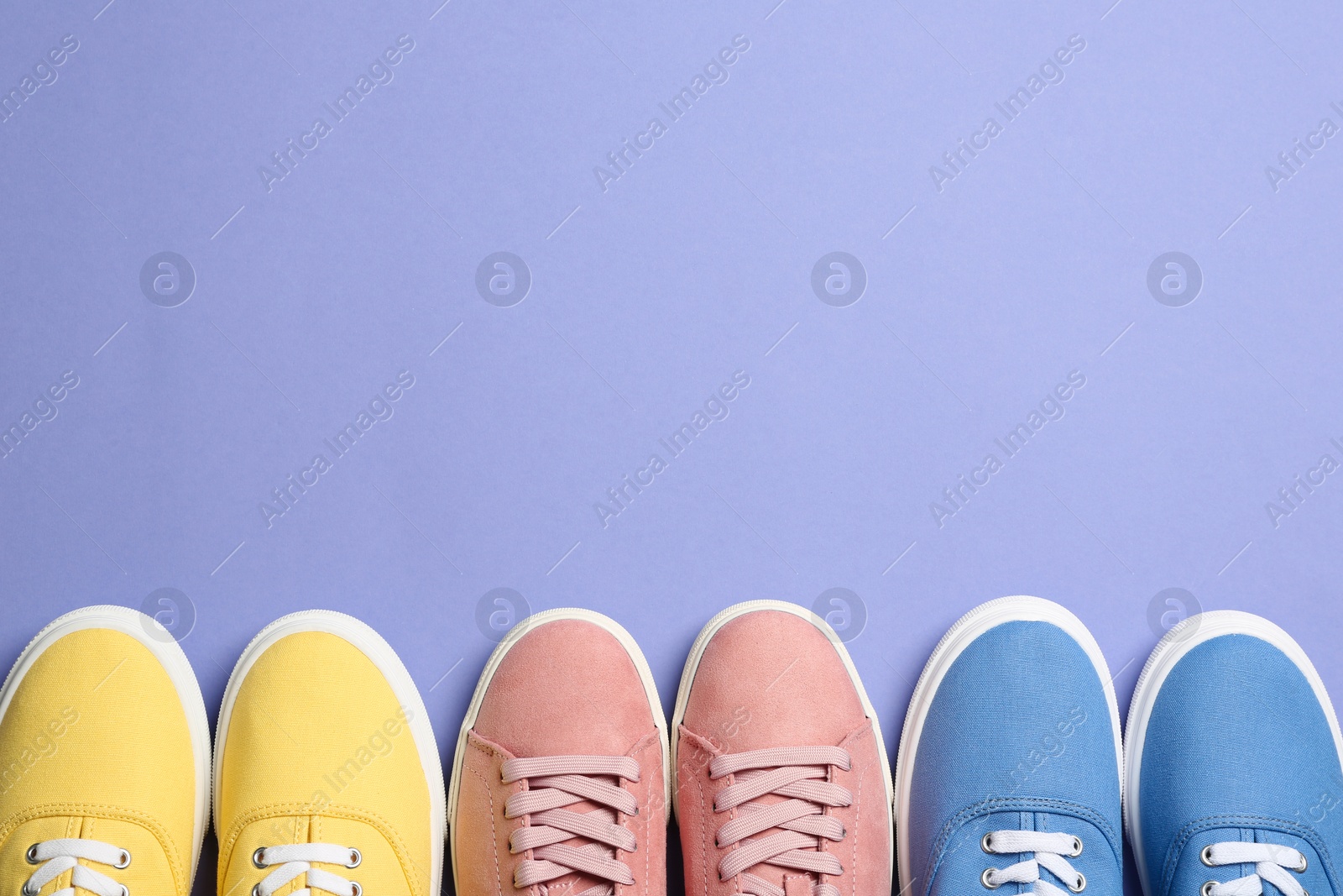 Photo of Different bright stylish shoes on color background, flat lay. Space for text