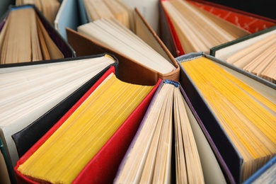 Photo of Stack of hardcover books as background, closeup