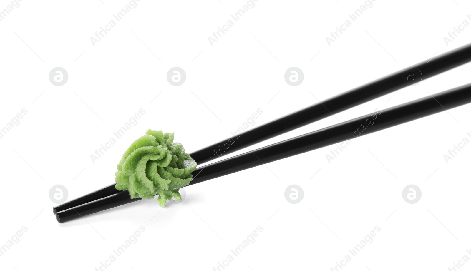 Photo of Chopsticks with swirl of wasabi paste isolated on white