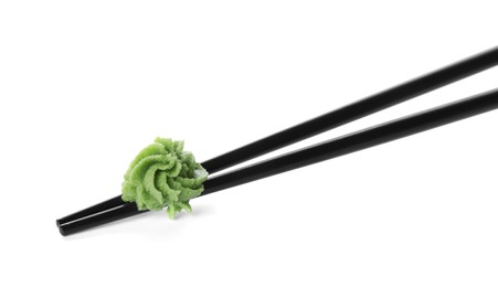 Photo of Chopsticks with swirl of wasabi paste isolated on white