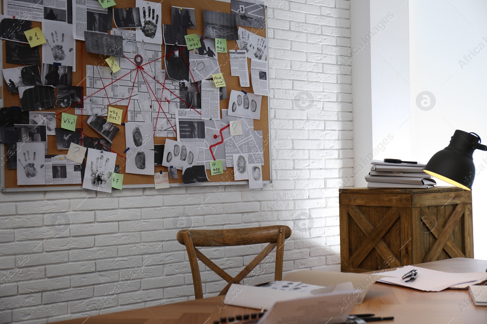 Photo of Detective office interior with workplace and investigation board