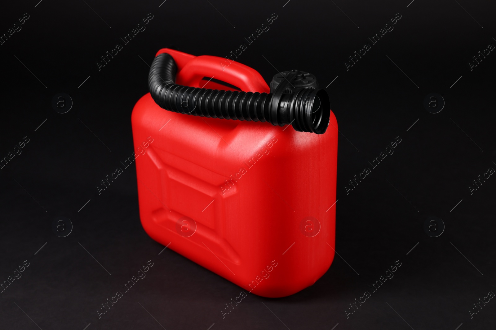 Photo of New red plastic canister on black background