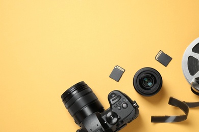 Photo of Flat lay composition with camera and video production equipment on yellow background. Space for text