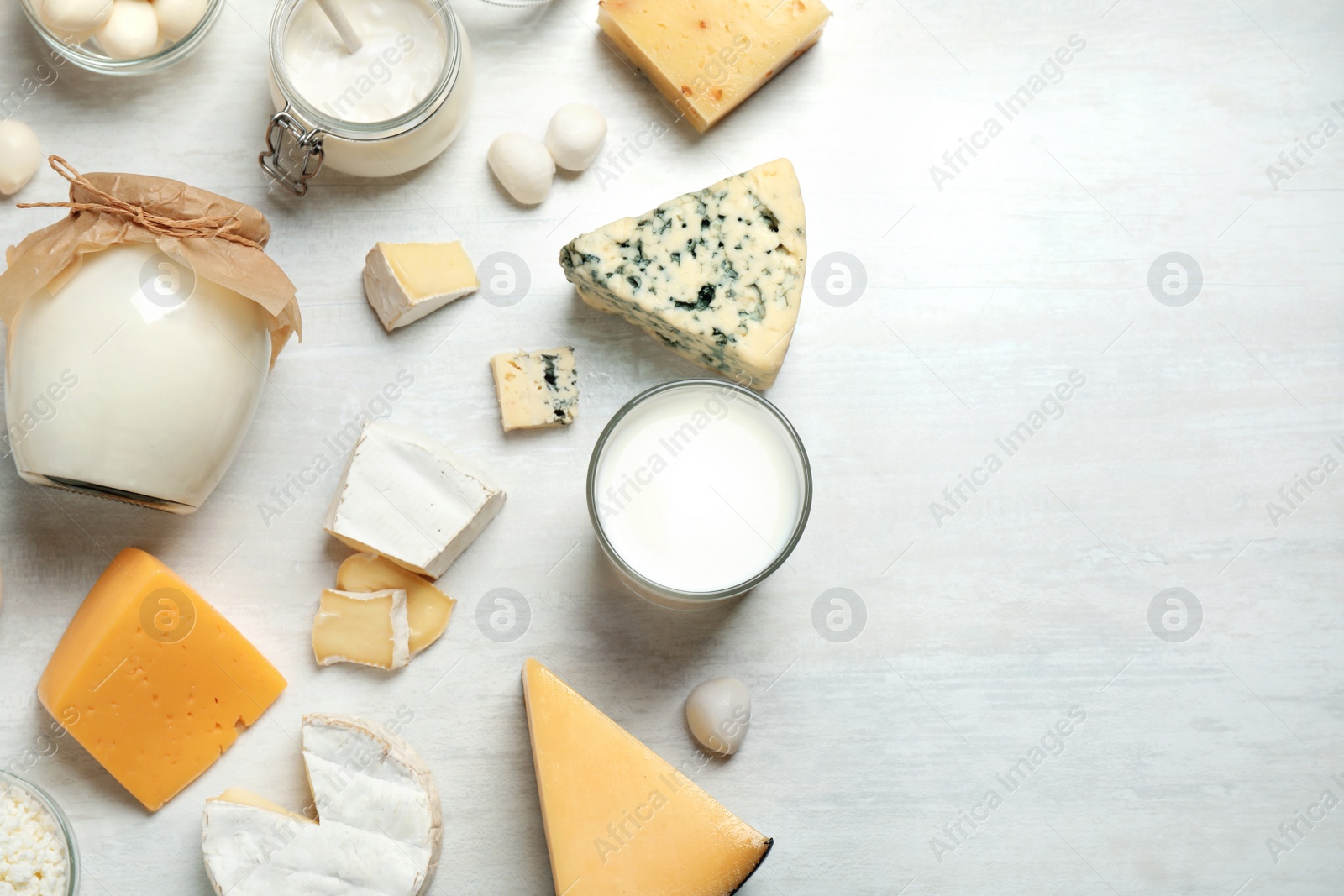 Photo of Different delicious dairy products on white table, flat lay. Space for text