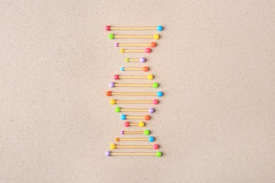 Model of DNA molecular chain on beige background, top view