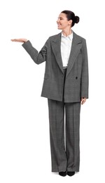 Beautiful businesswoman in suit pointing at something on white background