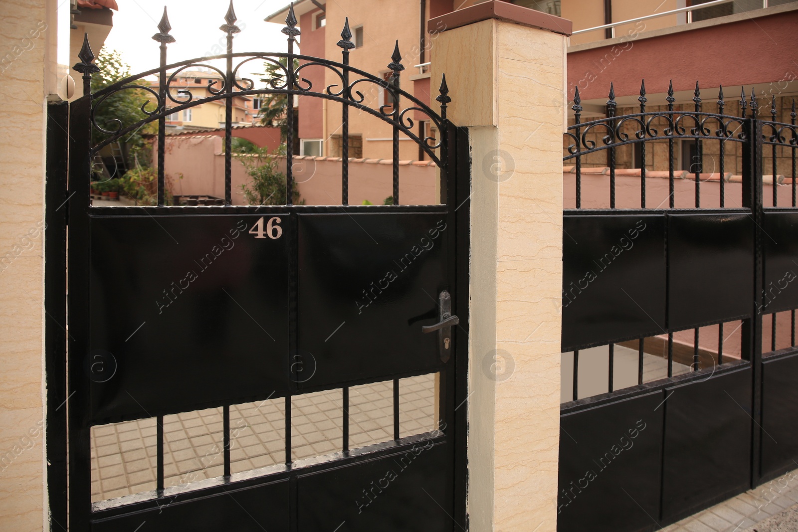 Photo of Plate with house number 46 on metal fence