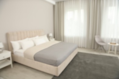 Blurred view of beautiful hotel room interior with double bed