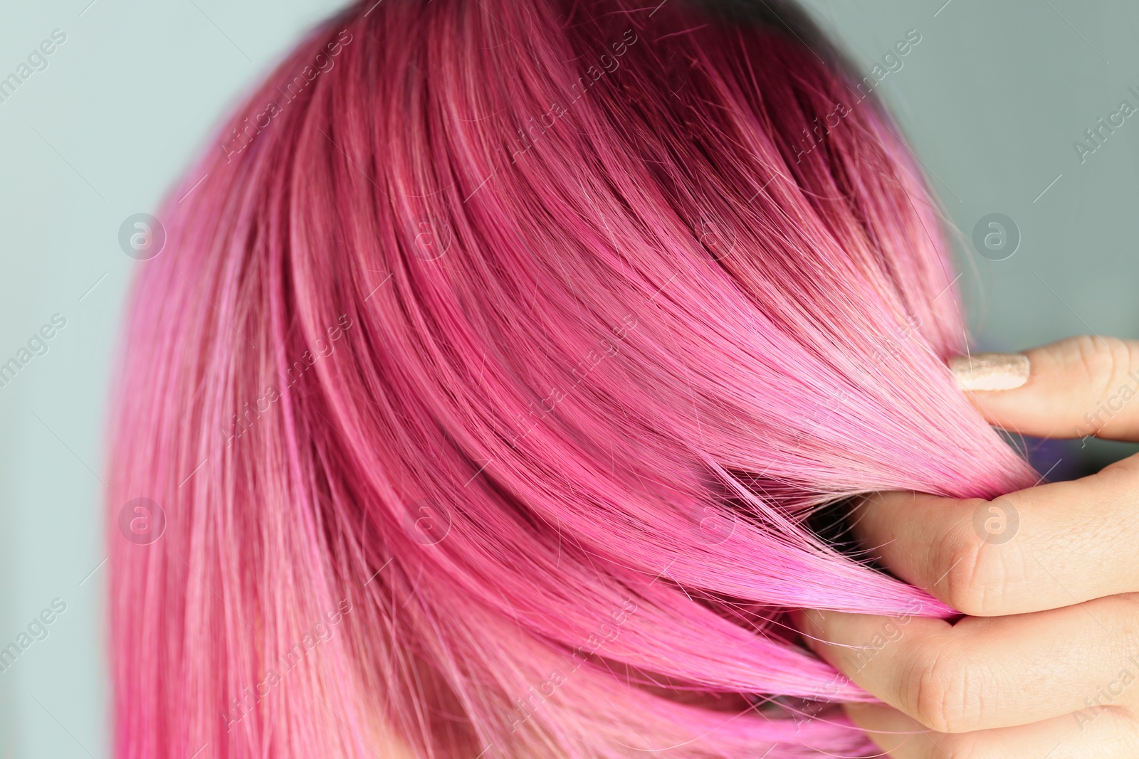Photo of Woman with color dyed hair, close up view. Trendy hairstyle