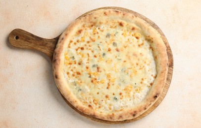 Photo of Delicious cheese pizza on beige textured table, top view