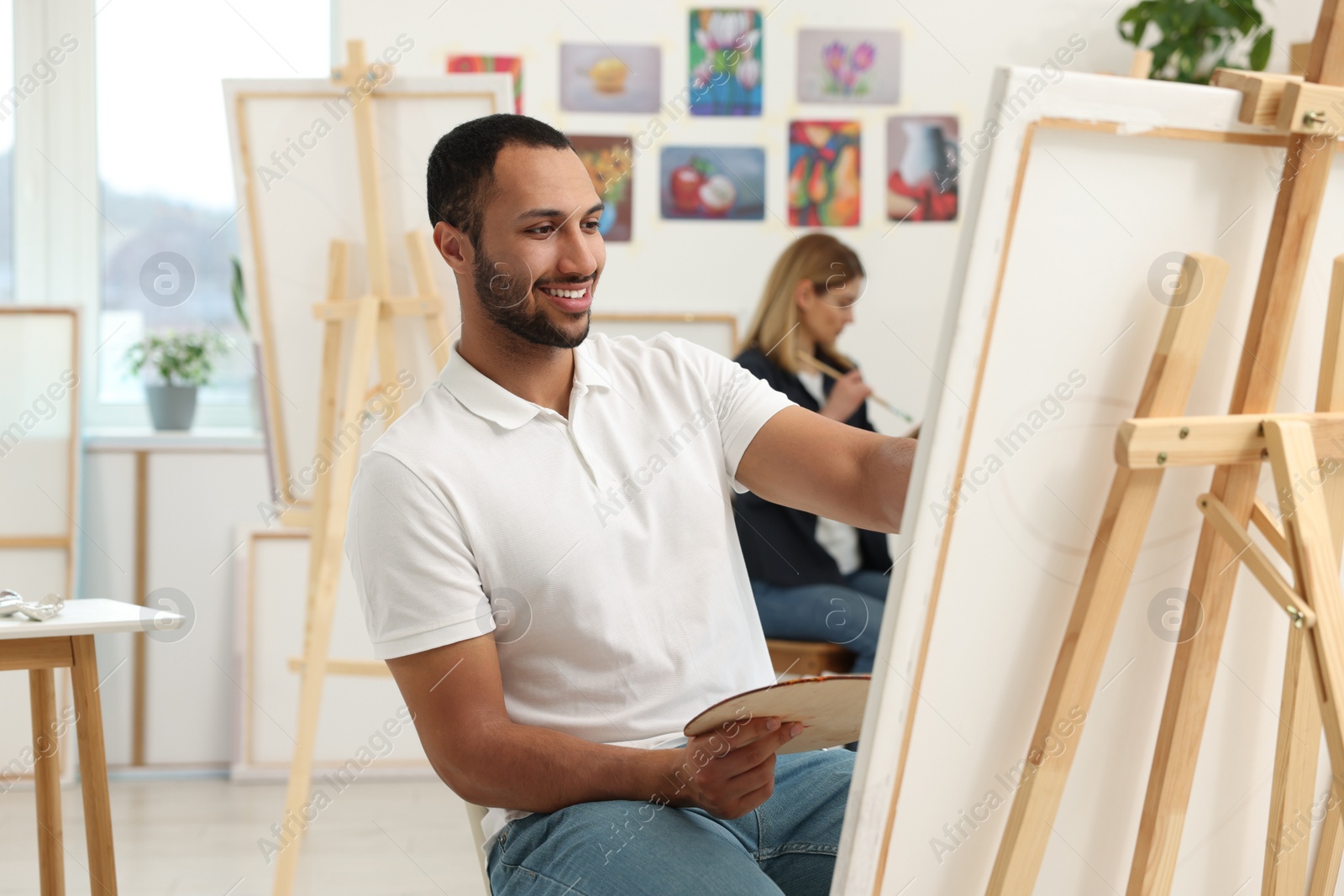 Photo of Students attending painting class in studio. Creative hobby