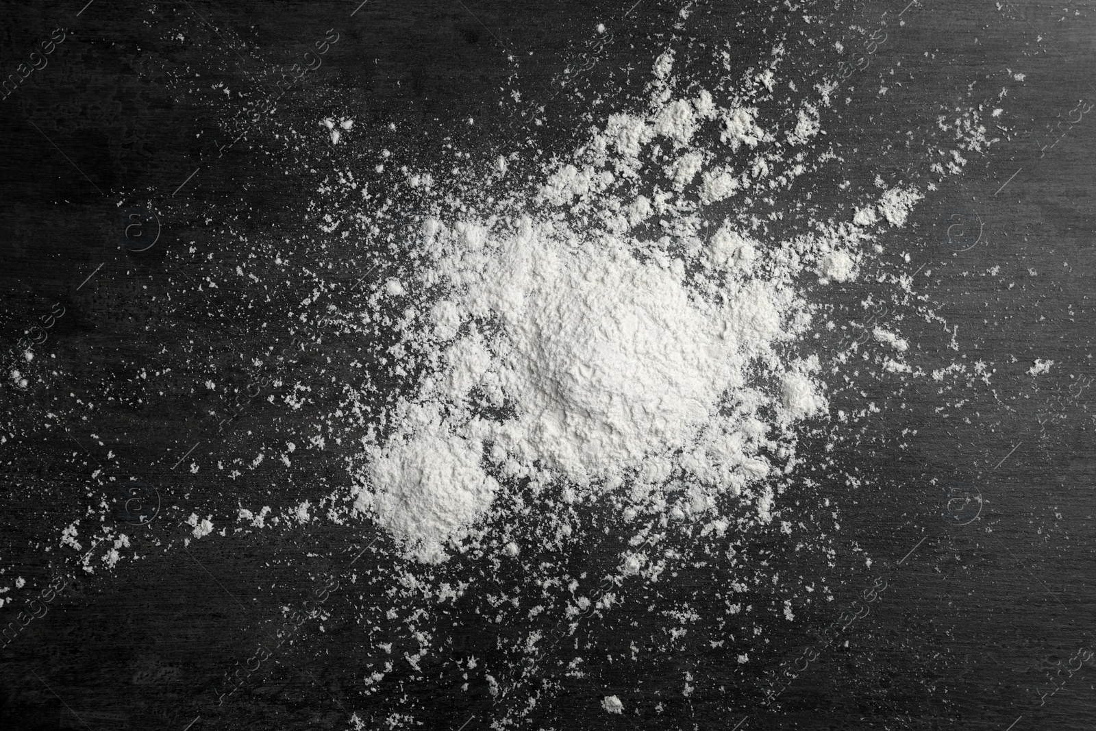 Photo of Scattered wheat flour on gray background, top view