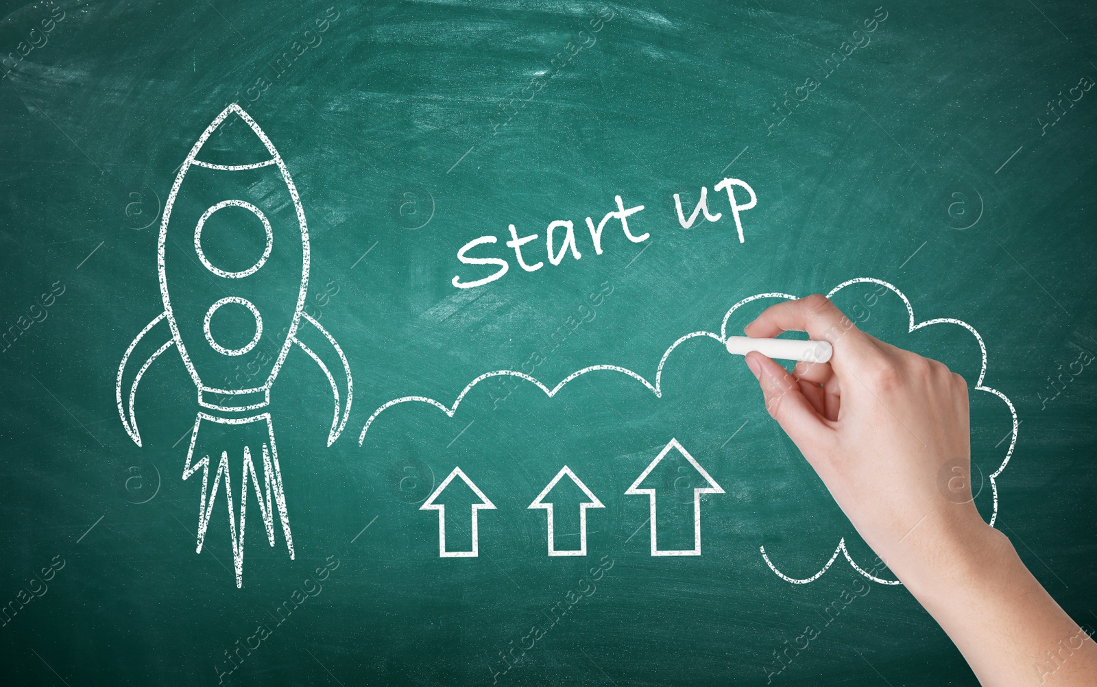 Image of Business startup concept. Woman drawing rocket on chalkboard, closeup