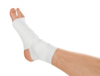 Photo of Man with foot wrapped in medical bandage on white background, closeup