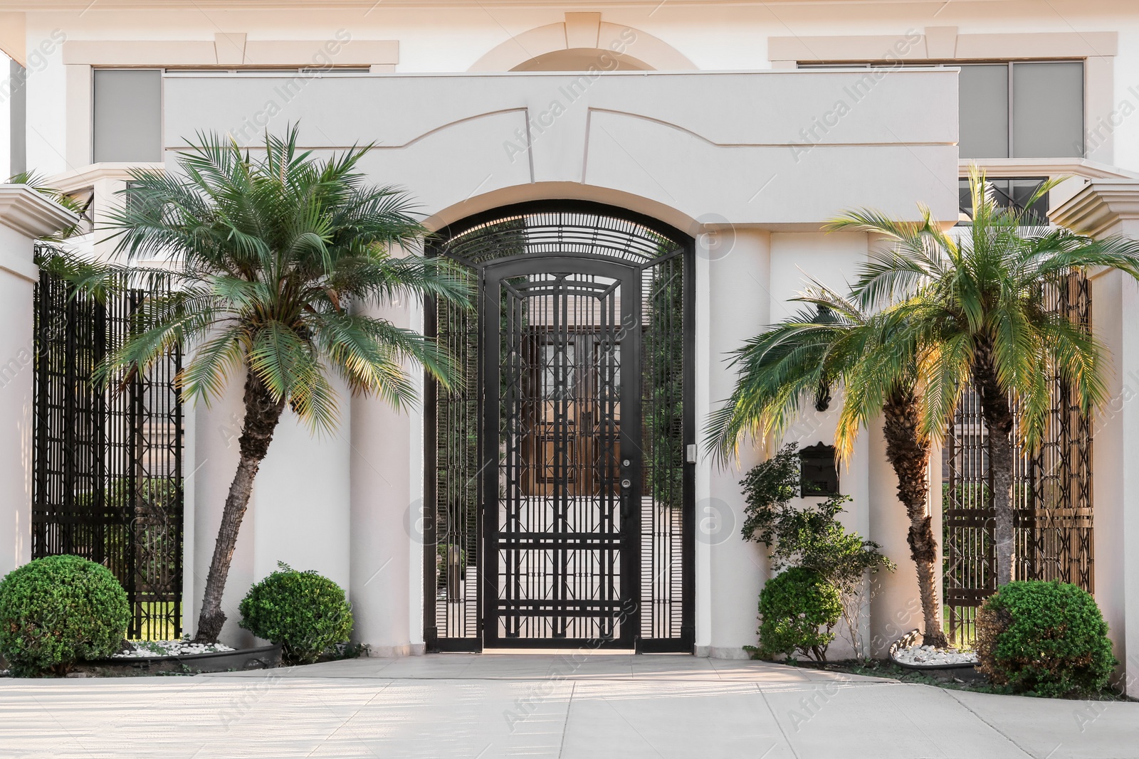 Photo of Closed metal door and fence outdoors on summer day