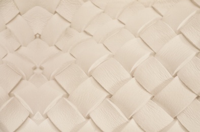 Photo of White plaited leather surface as background, closeup