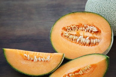 Tasty orange ripe melons on wooden table