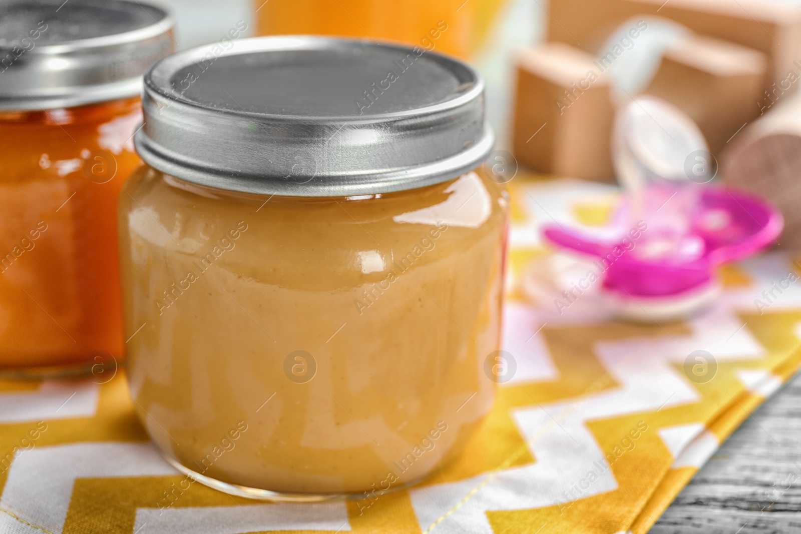 Photo of Jar with healthy baby food on table