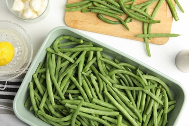 Photo of Flat lay composition with raw green beans on white table