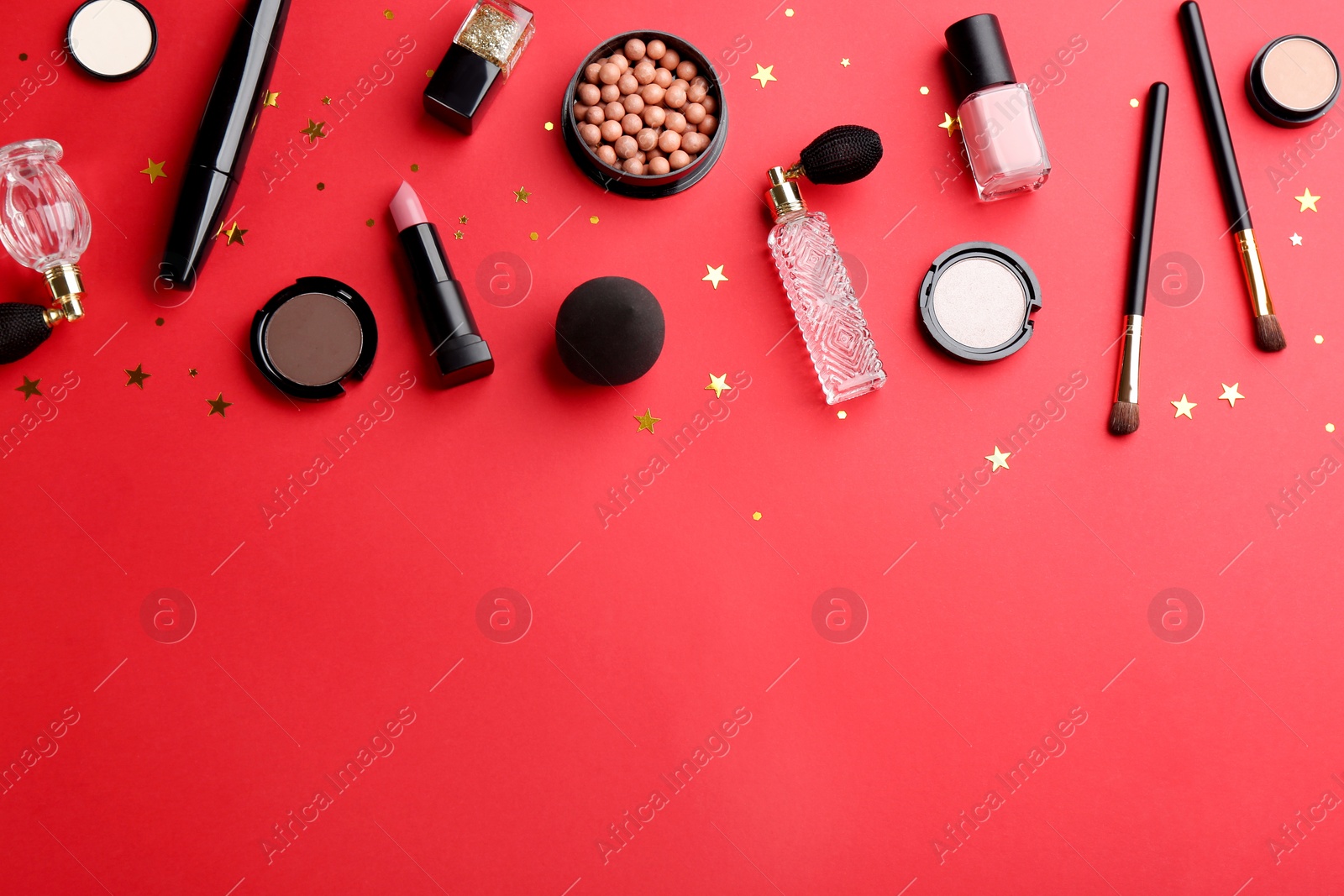 Photo of Flat lay composition with decorative cosmetic products on red background, space for text. Winter care