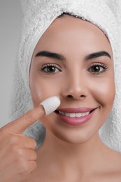 Photo of Woman using silkworm cocoon in skin care routine, closeup