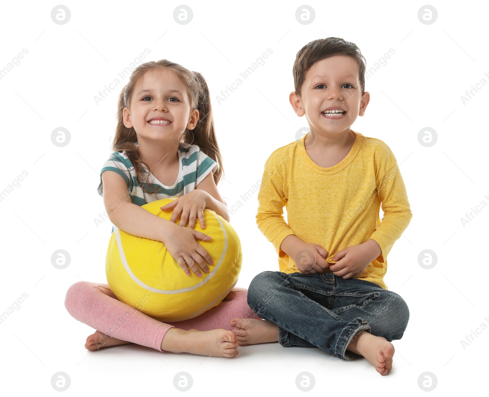 Photo of Cute little boy and girl with soft ball on white background