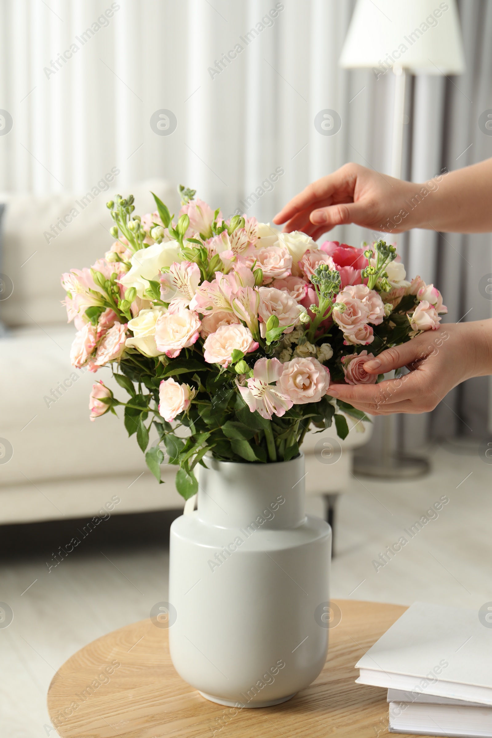 Photo of Woman with beautiful bouquet of fresh flowers at home, closeup