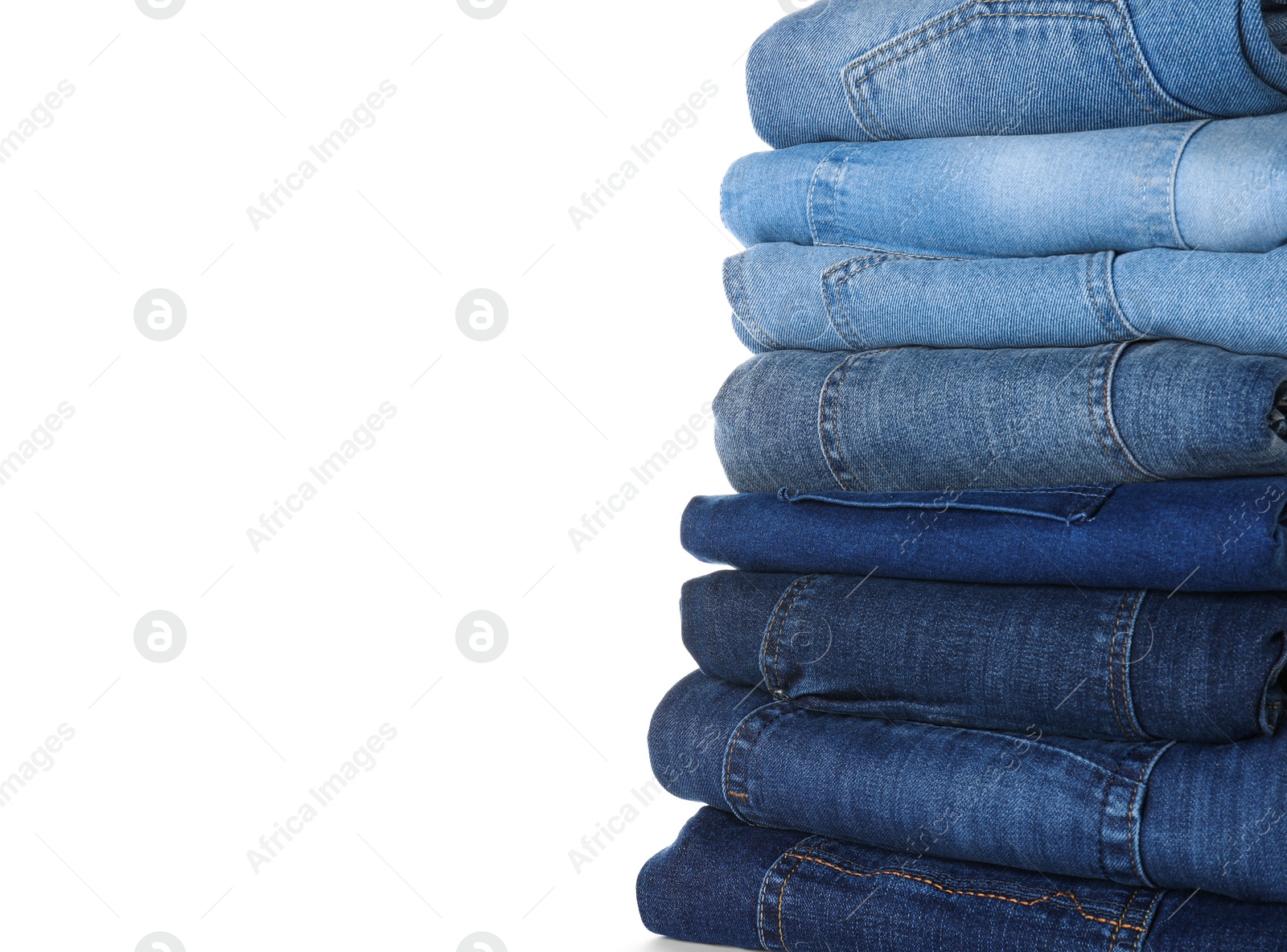 Photo of Stack of different jeans isolated on white