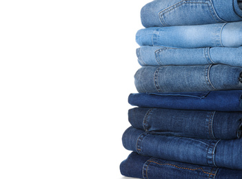 Photo of Stack of different jeans isolated on white