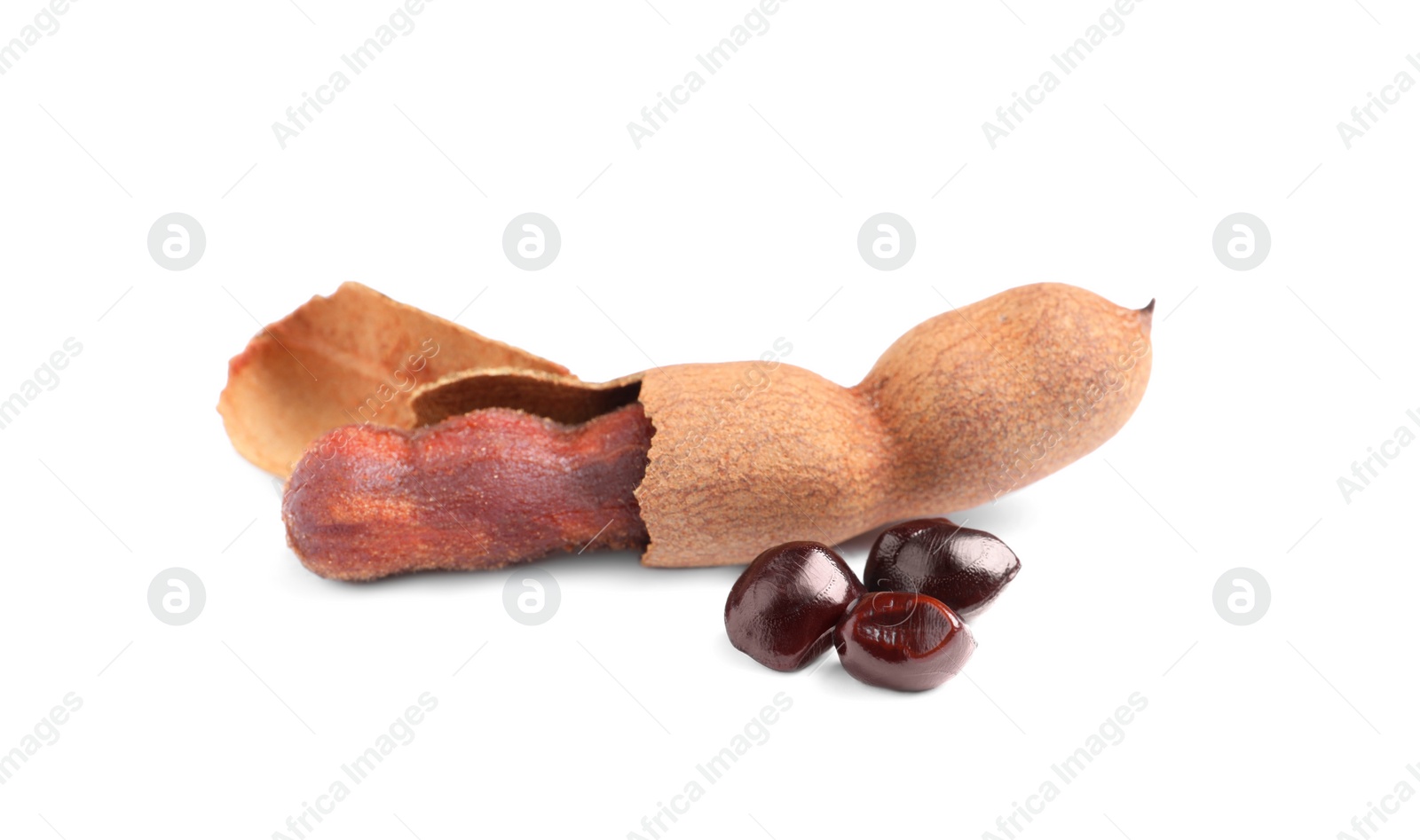 Photo of Delicious ripe tamarinds and seeds on white background. Exotic fruit