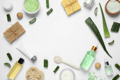 Photo of Flat lay composition with aloe vera and cosmetic products on white background. Space for text