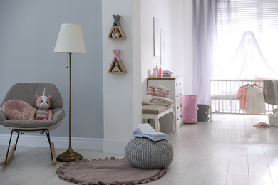 Cozy baby room interior with comfortable rocking chair