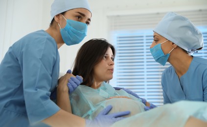 Photo of Woman giving child birth in maternity hospital