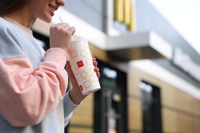 Photo of Lviv, Ukraine - September 26, 2023: Woman with McDonald's drink outdoors, closeup. Space for text