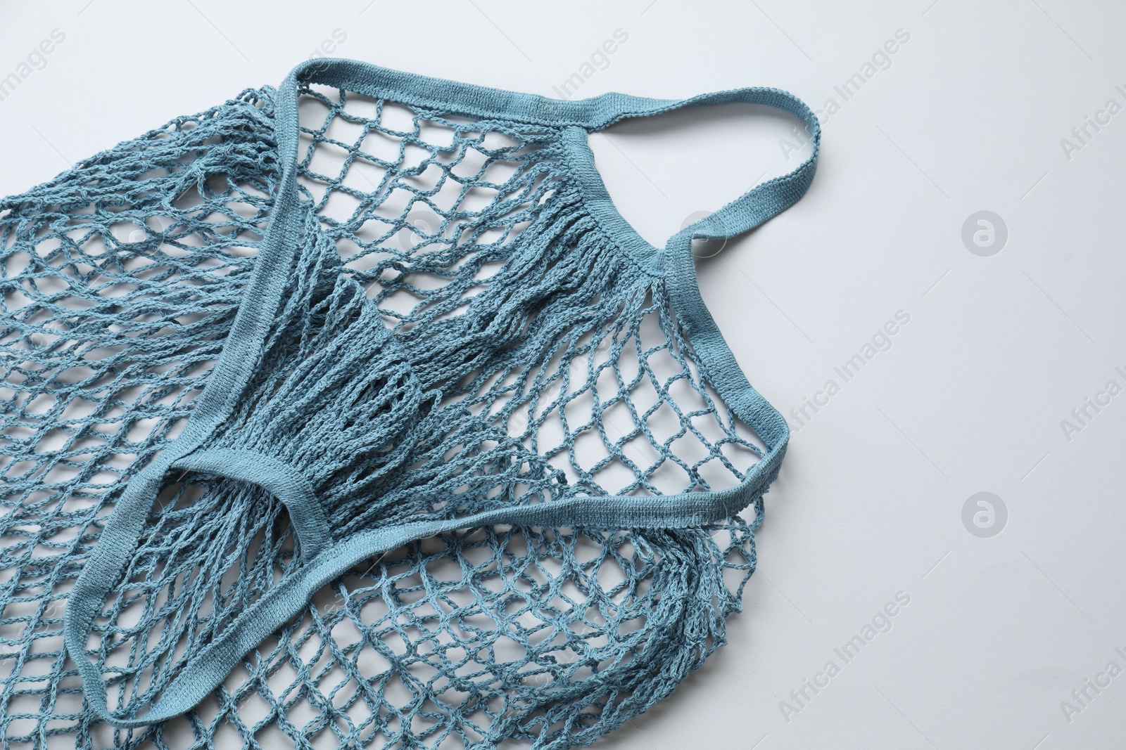 Photo of Blue string bag on light grey background, top view