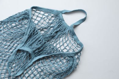 Photo of Blue string bag on light grey background, top view