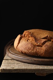 Photo of Freshly baked sourdough bread on wooden table