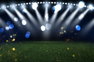 Image of Green sports field under stadium lights, bokeh effect