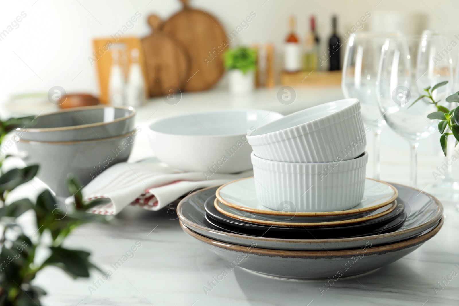 Photo of Set of beautiful tableware on white table in kitchen. Space for text