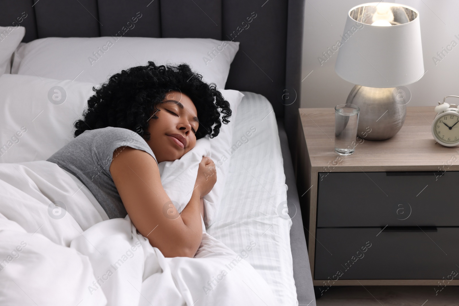 Photo of Beautiful young woman sleeping in soft bed at home