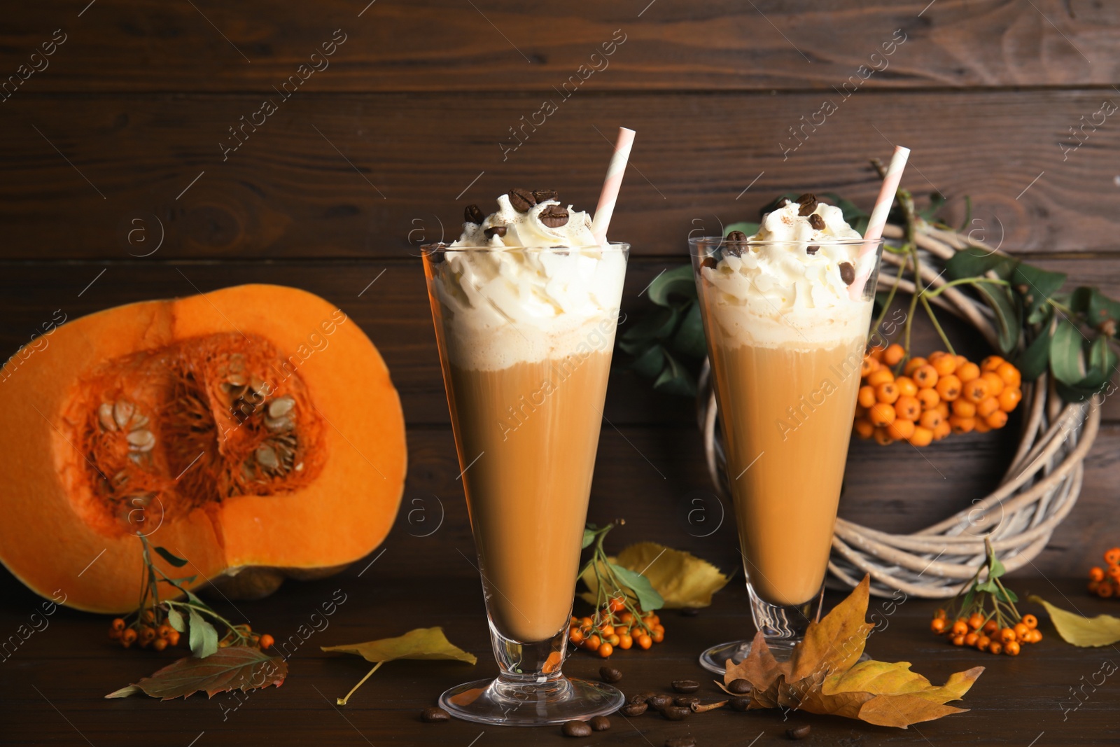 Photo of Composition with tasty pumpkin spice latte on table