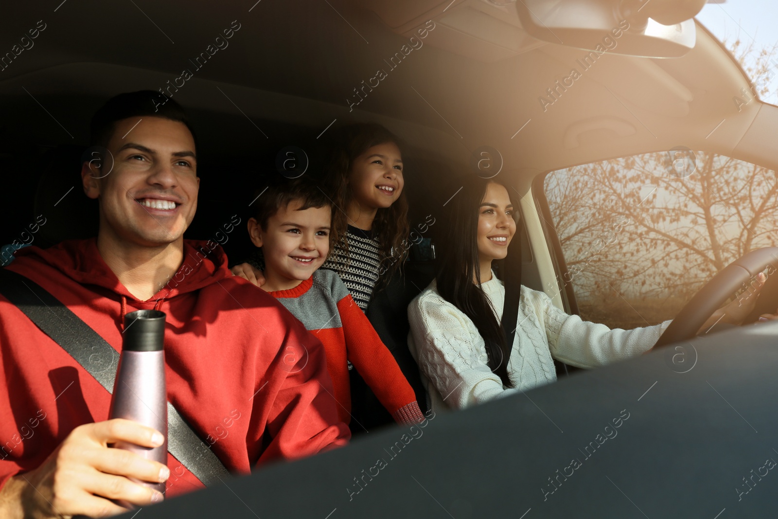 Photo of Happy family with little children inside modern car