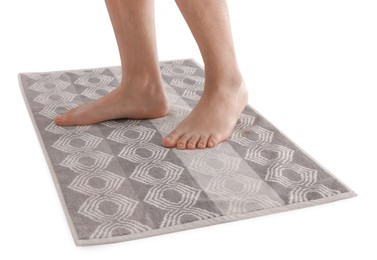 Man standing on stylish bath mat against white background, closeup